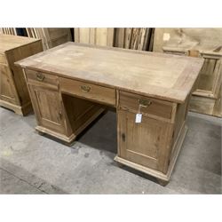 20th century pine twin pedestal desk, rectangular top over three drawers and two cupboards, enclosed by panelled doors, on turned feet - THIS LOT IS TO BE COLLECTED BY APPOINTMENT FROM THE OLD BUFFER DEPOT, MELBOURNE PLACE, SOWERBY, THIRSK, YO7 1QY