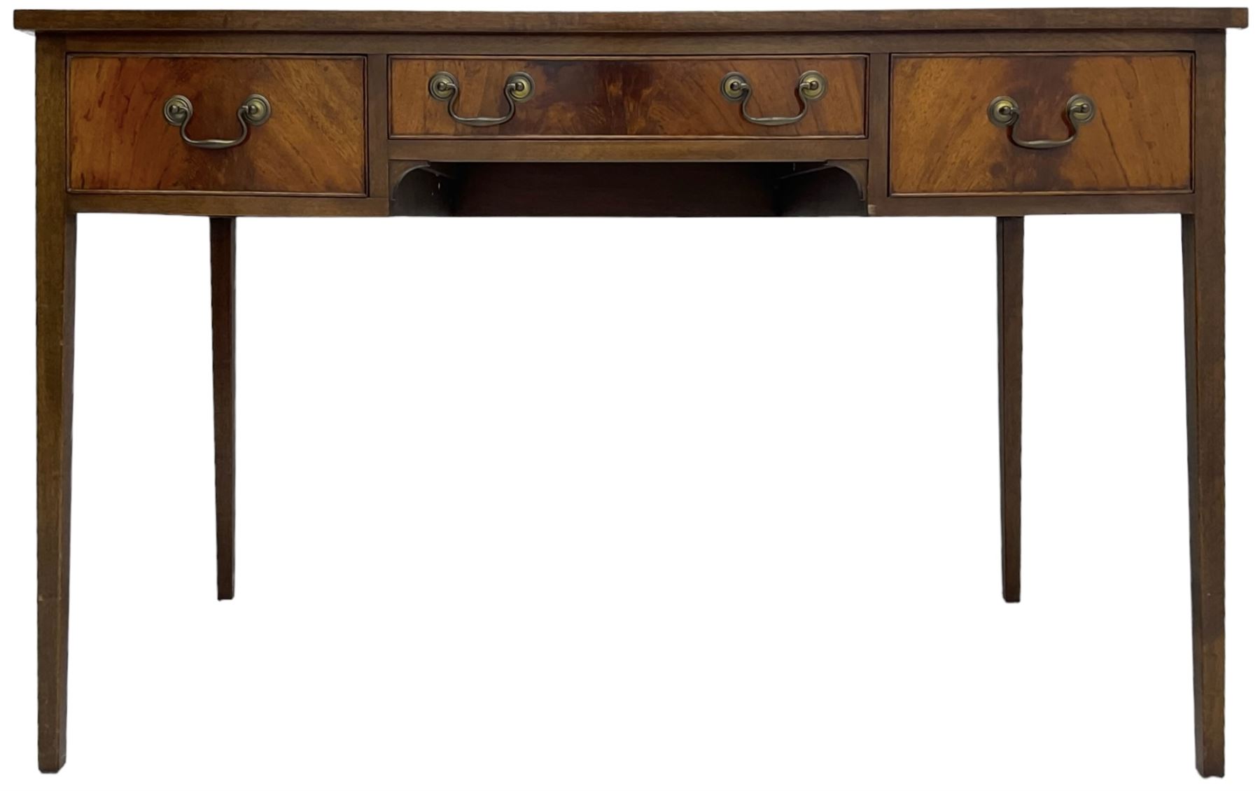 Mid-to-late 20th century mahogany writing desk, the rectangular top with a tooled red leather insert bordered with gilt detailing, three cock-beaded drawers with brass handles, the narrow central drawer flanked by two wider drawers, standing on square tapered legs