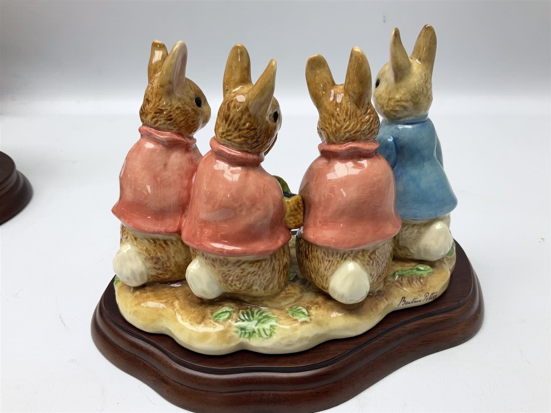 Four Border Fine Arts Beatrix Potter figures, comprising Tableau created to commemorate the Millenium together with a Border Fine Arts Limited Edition no 669814, The Tale of Peter Rabbit Tablet A1306, Four Little Rabbits A2442 and Sailing Home A2443