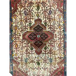 Small Persian rug, ivory and pale red ground, decorated with central medallion within a field of trailing Boteh motifs, geometric design guarded border