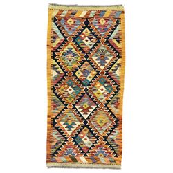 Chobi Kilim multicoloured ground runner, displaying diamond-shaped motifs in shades of blue, red, yellow, and green, accented by a bold black outline and bordered with a striped design, flatwoven with fringed edges