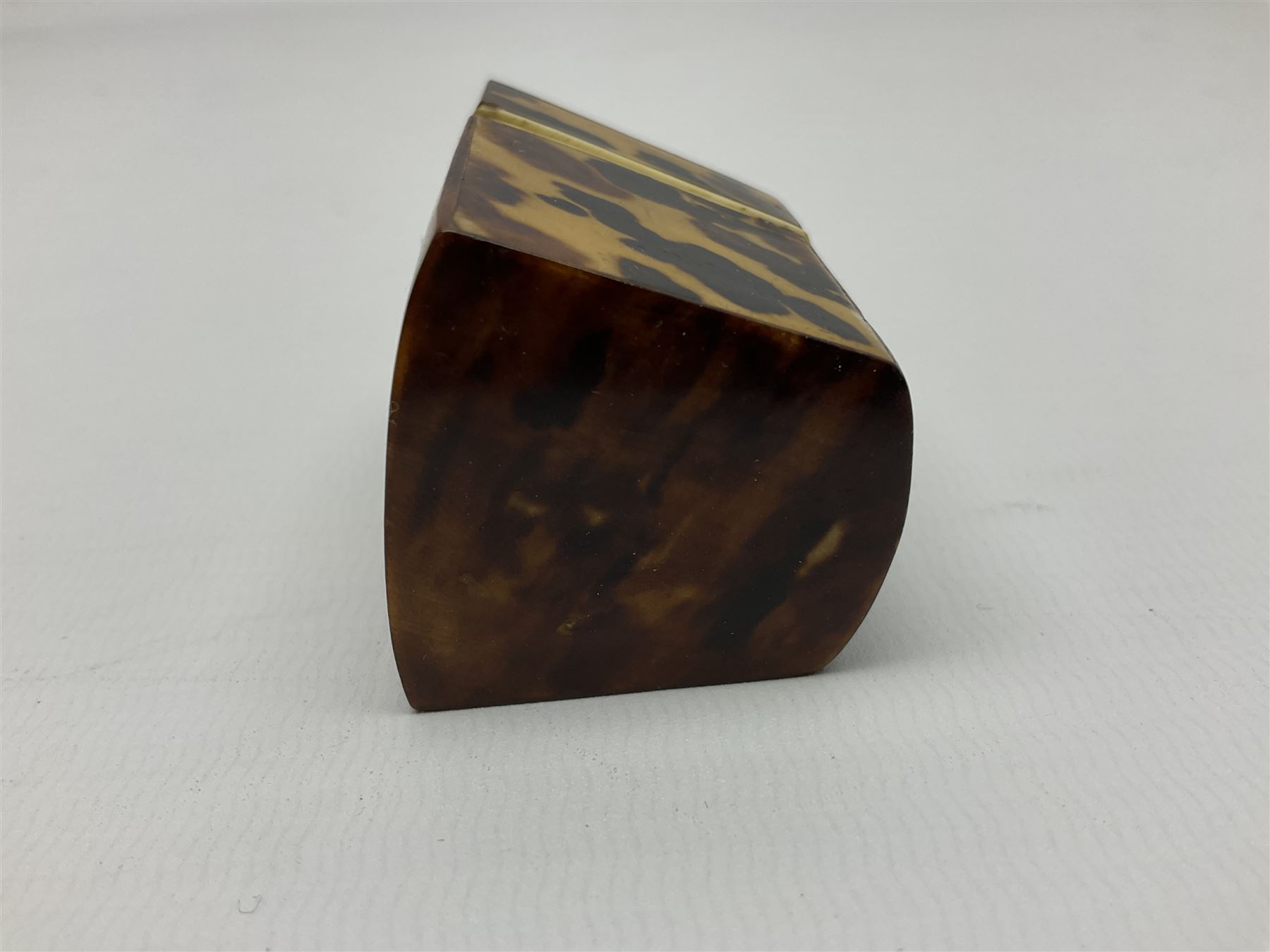 19th century tortoiseshell needle packet box of wedge form, with compartmented interior, H5.5cm, together with a 19th century tortoiseshell card or note case of book form, with inlaid silver motif to centre, the interior with card pocket, H7cm W7cm, (2)