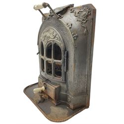 La Salamandre - early 20th century cast iron wood burning stove, decorated with salamander and cartouche motifs, fitted with porcelain handle, on rear castors 