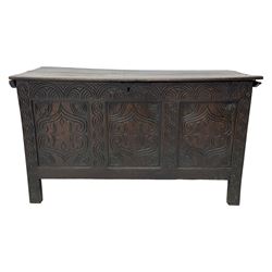 18th century oak blanket box, moulded and chip carved hinged lid, lunette carved cresting rail over triple panelled front carved with stylised leaf and scroll decoration, interlocking S-scroll carved upright rails, panelled sides and back, on stile supports 