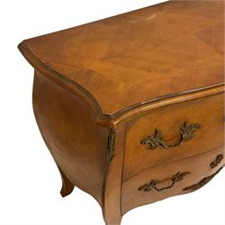 Late 20th century French design walnut bombe chest, shaped moulded top with quarter-matched veneers within crossbanding, fitted with two drawers with foliate cast metal handles and escutcheons, on tapering supports with ornate cast caps 