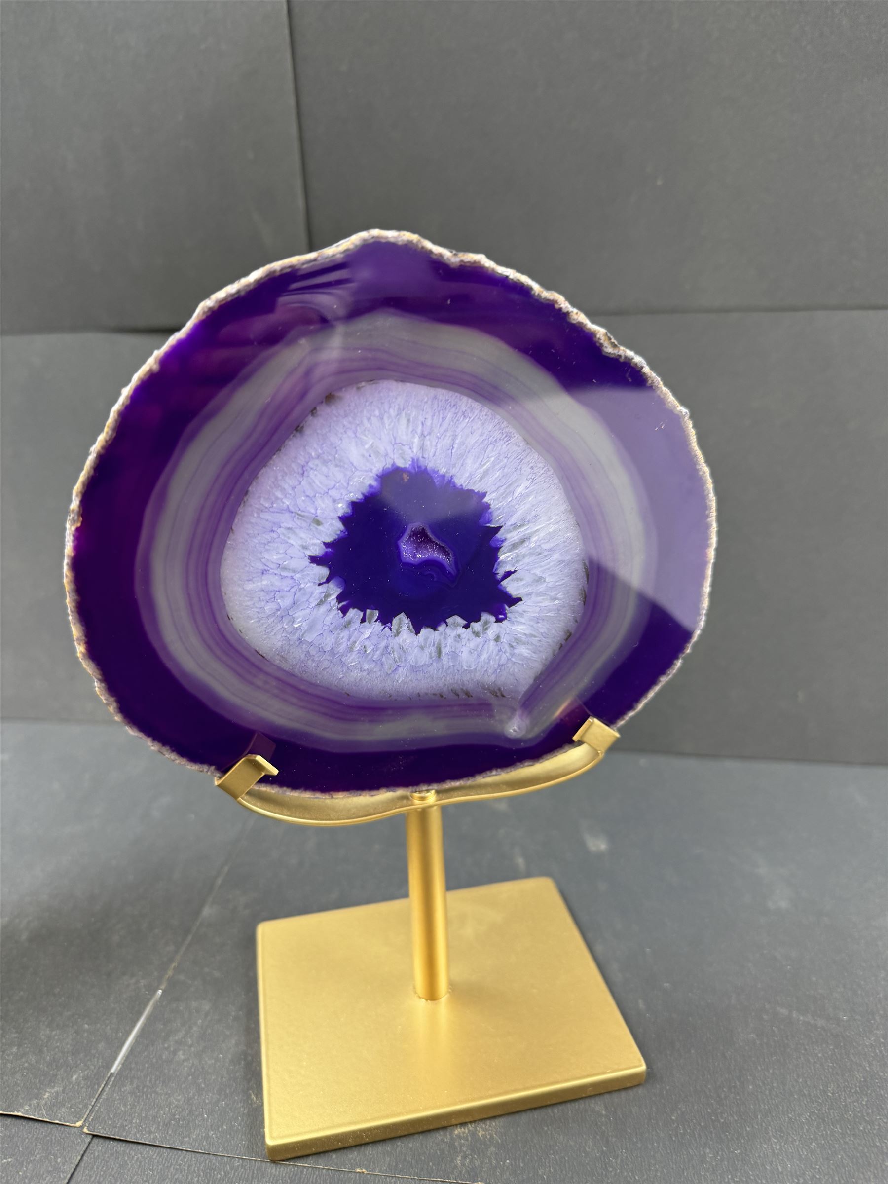 Pair of purple agate slices, polished with rough edges, raised upon gilt metal stands, H22cm