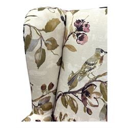 Hardwood-framed wingback armchair, upholstered in cream floral pattern fabric, on turned front feet