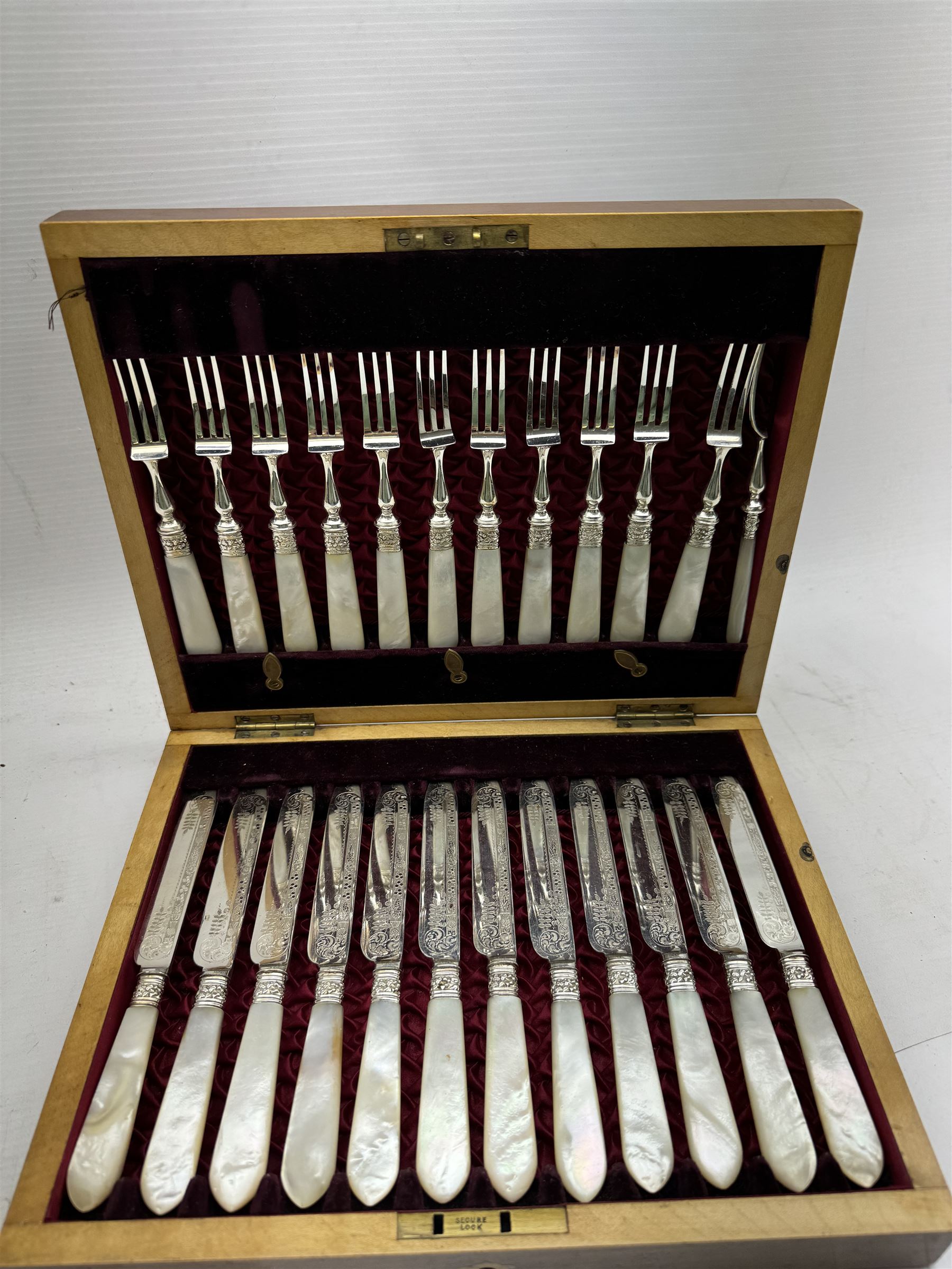 Set of twelve early 20th century century mother of pearl handled and silver plated fruit knives and forks, housed in a satin and velvet lined mahogany case, together with a 