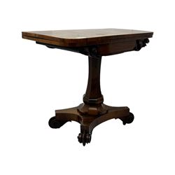 Early Victorian rosewood card table, rectangular foldover swivel top with rounded corners, red baize-lined surface, frieze adorned with carved foliate motifs, supported by a central octagonal waisted column on shaped quatrefoil base, terminating in scrolled feet with concealed metal castors