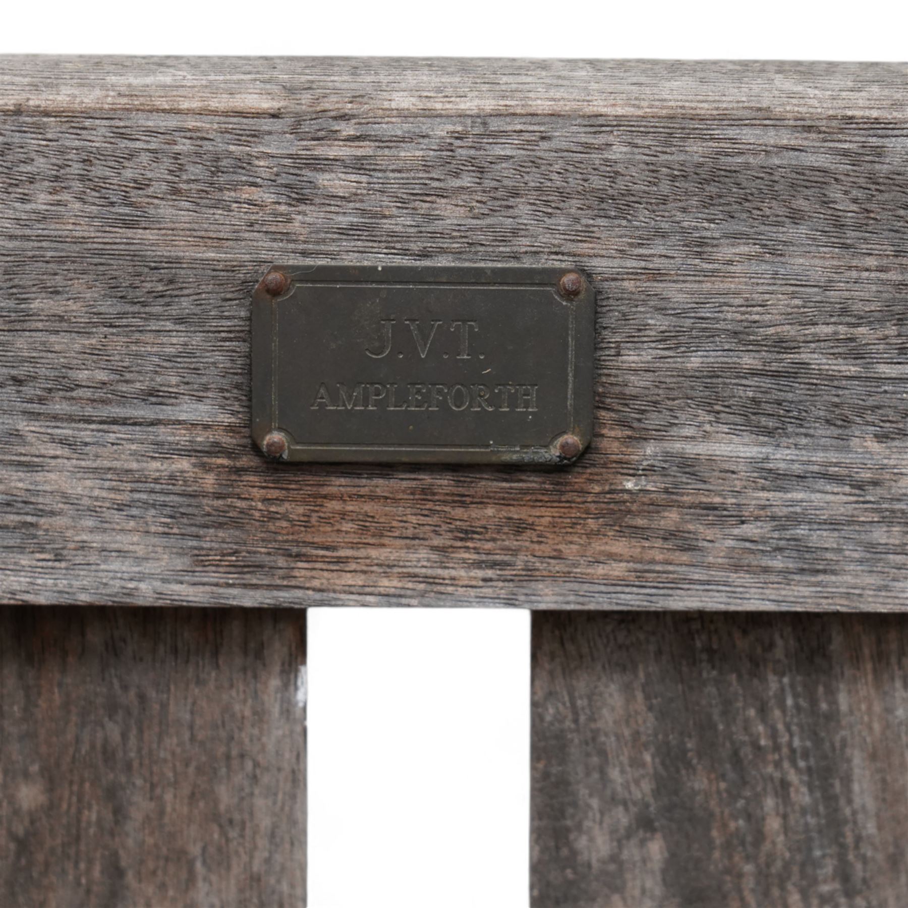 'J.V.T. Ampleforth' - teak garden bench, plain cresting rail with applied maker's plaque over slatted back and seat, on square supports 