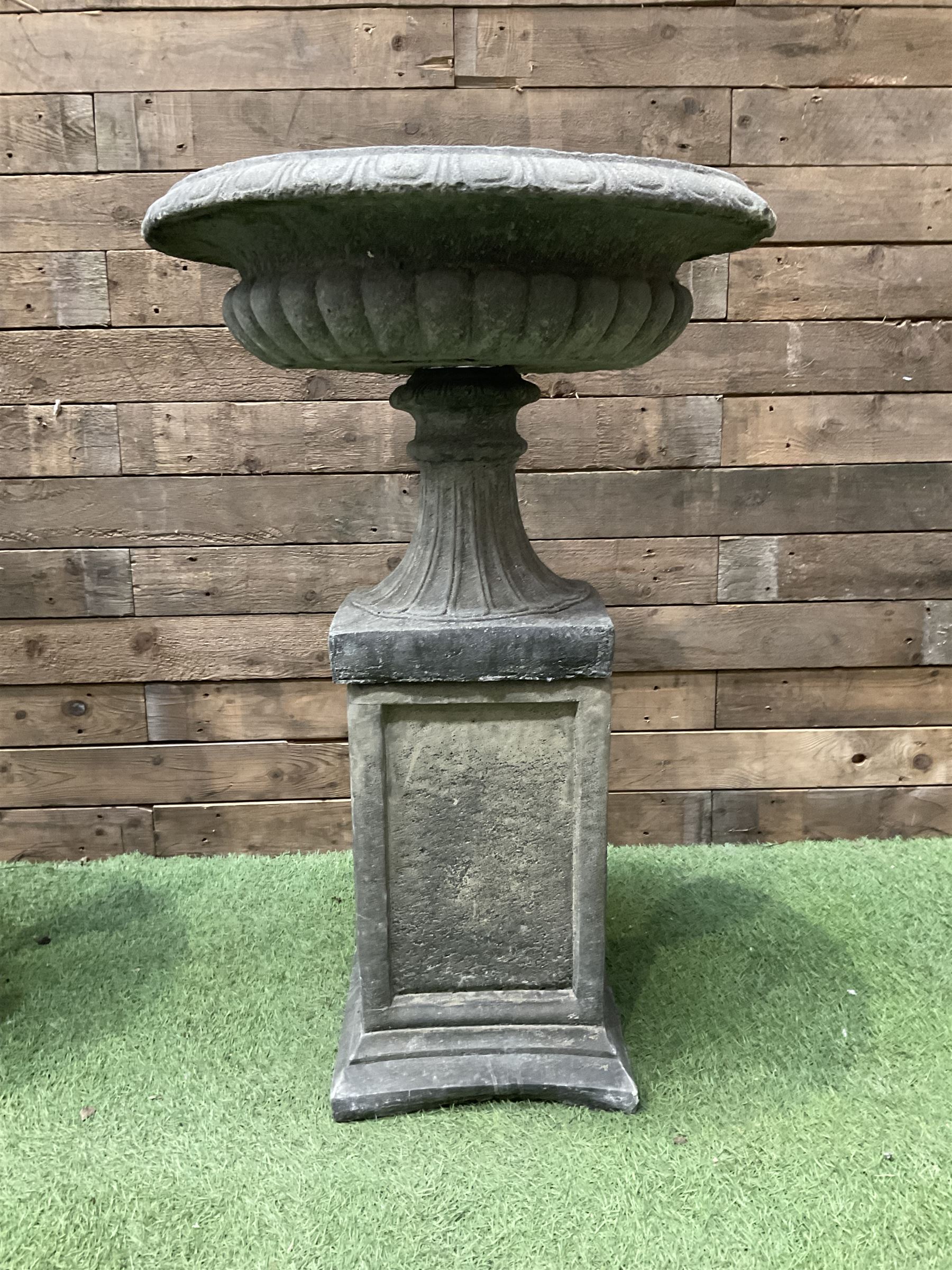 Pair of Victorian design cast stone squat garden urns, egg and dart border, raised on pedestal base and square fielded plinth - THIS LOT IS TO BE COLLECTED BY APPOINTMENT FROM DUGGLEBY STORAGE, GREAT HILL, EASTFIELD, SCARBOROUGH, YO11 3TX