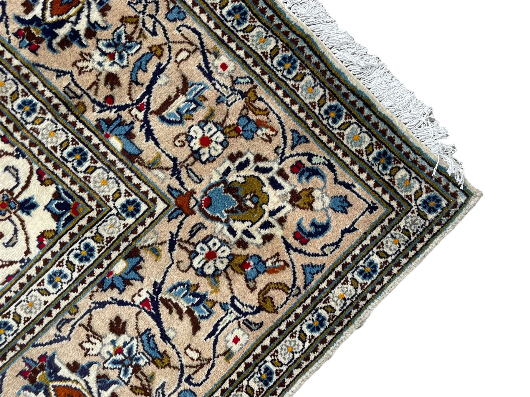 Persian Kashan ivory ground rug, central floral medallion surrounded by interlacing leafy branches and stylised plant motifs, scrolling spandrels, the border decorated with trailing branch and repeating palmettes, within floral pattern guard stripes 