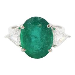 18ct white gold three stone oval cut emerald and trillion cut diamond ring, stamped, emerald approx 5.65 carat, total diamond weight approx 0.65 carat