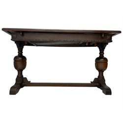 Early 20th century oak extending table, moulded rectangular top, pull-out action with fold-out leaf, on turned cup and cover pedestals and sledge feet, united by moulded stretcher 