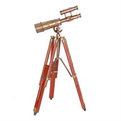 Brass telescope upon a wooden adjustable tripod, H55cm 