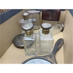 Silver mounted hand mirror and glass vanity bottles/jars with silver caps, all hallmarked, together with silver plated teapot, serving dishes and glass hip flask