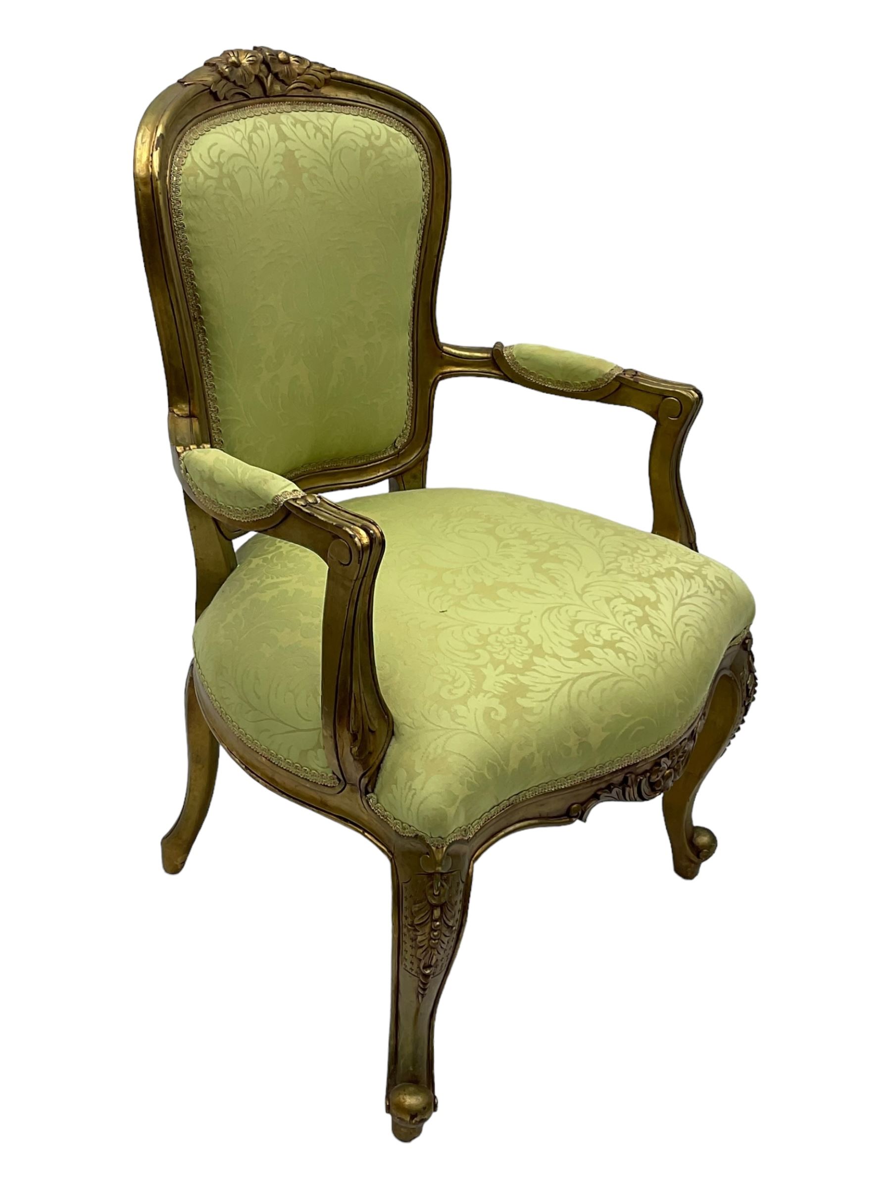 Late 20th century French design gilt framed armchair, upholstered in lime green damask fabric, arched back with carved crest, scroll arms, serpentine front rail, on cabriole front supports with ball feet