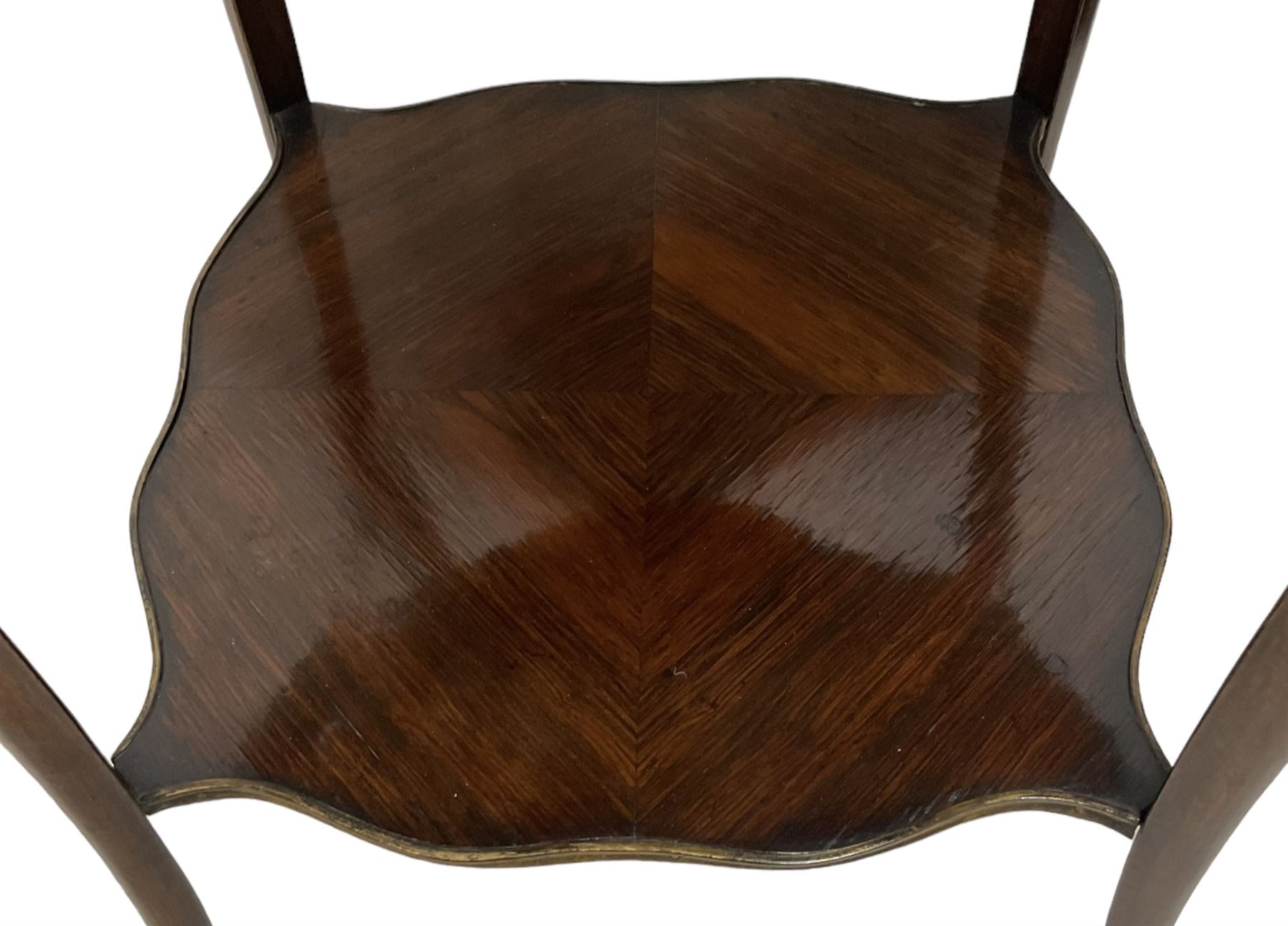 Early 20th century French two-tier marquetry inlaid walnut side table, shaped circular top with gilt metal edge, central chequered inlaid circular panel with floral motif, raised on cabriole supports with gilt metal mounts, united  by undertier