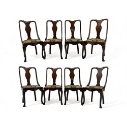 Set of eight late 19th century mahogany spoon back dining chairs, each with shaped top rail over Queen Anne design vase-shaped splat, upholstered seats in floral patterned fabric, raised on cabriole supports with scroll carved knees