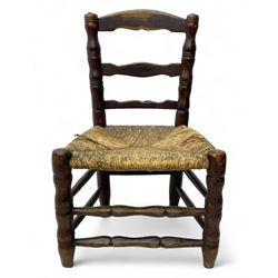 19th century painted elm primitive fire side chair, ladder back over rush seat, on turned supports united by turned stretchers 