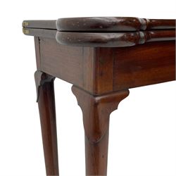 George III mahogany games table, the rectangular fold-over top with extending stepped rounded corners, opening to reveal baize lined interior with sunken counter wells, concertina action base, on lappet cabriole supports