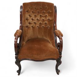 Victorian mahogany framed drawing room chair, scrolled back with bell-flower mouldings over scrolled arm terminals, upholstered in buttoned hazelnut brown fabric with sprung seat, cabriole supports on castors