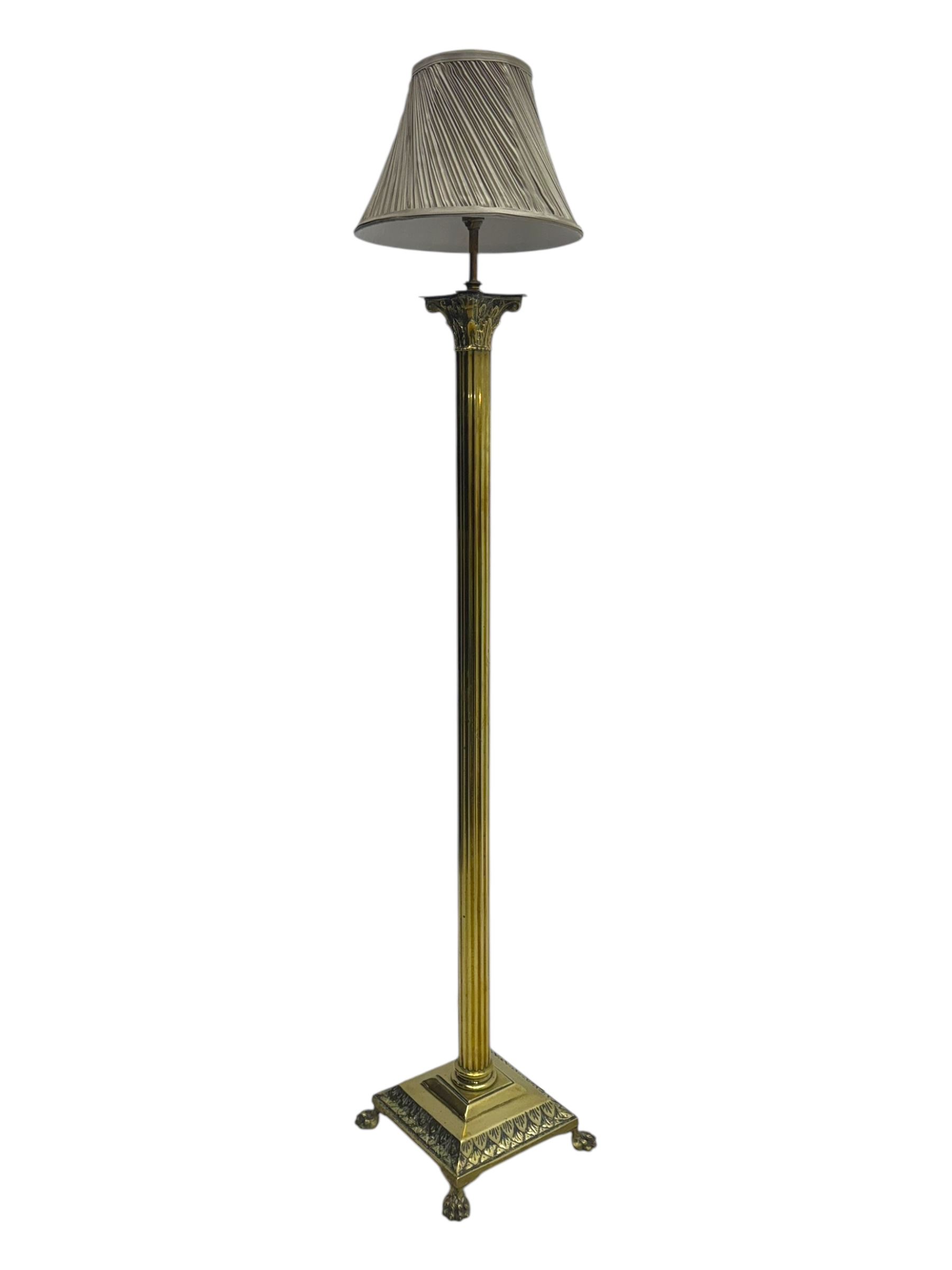 20th century brass standard lamp, Corinthian column stem on moulded square base with paw feet 