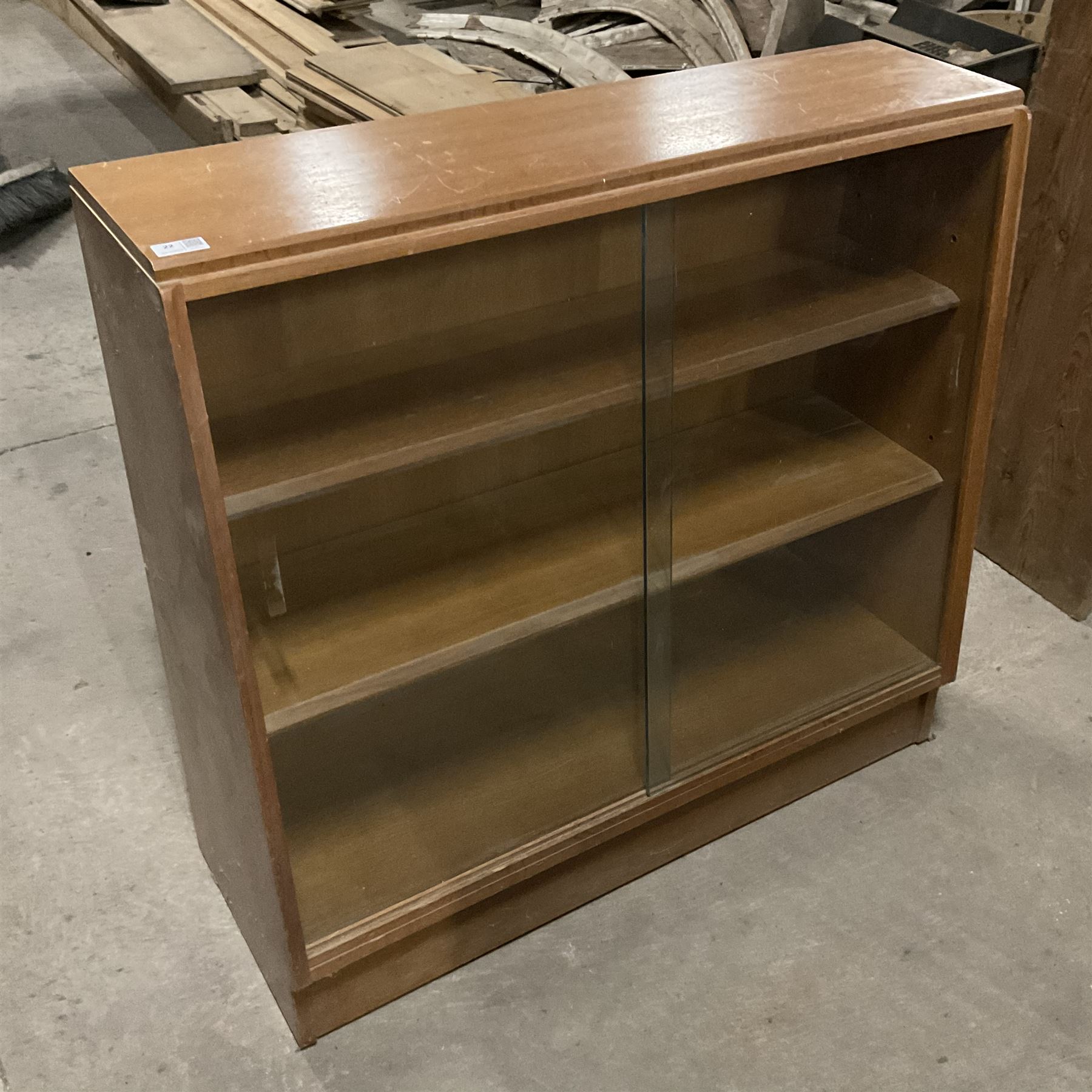 Mid-20th century oak library bookcase, sloped form and fitted with two sliding glass doors - THIS LOT IS TO BE COLLECTED BY APPOINTMENT FROM THE OLD BUFFER DEPOT, MELBOURNE PLACE, SOWERBY, THIRSK, YO7 1QY