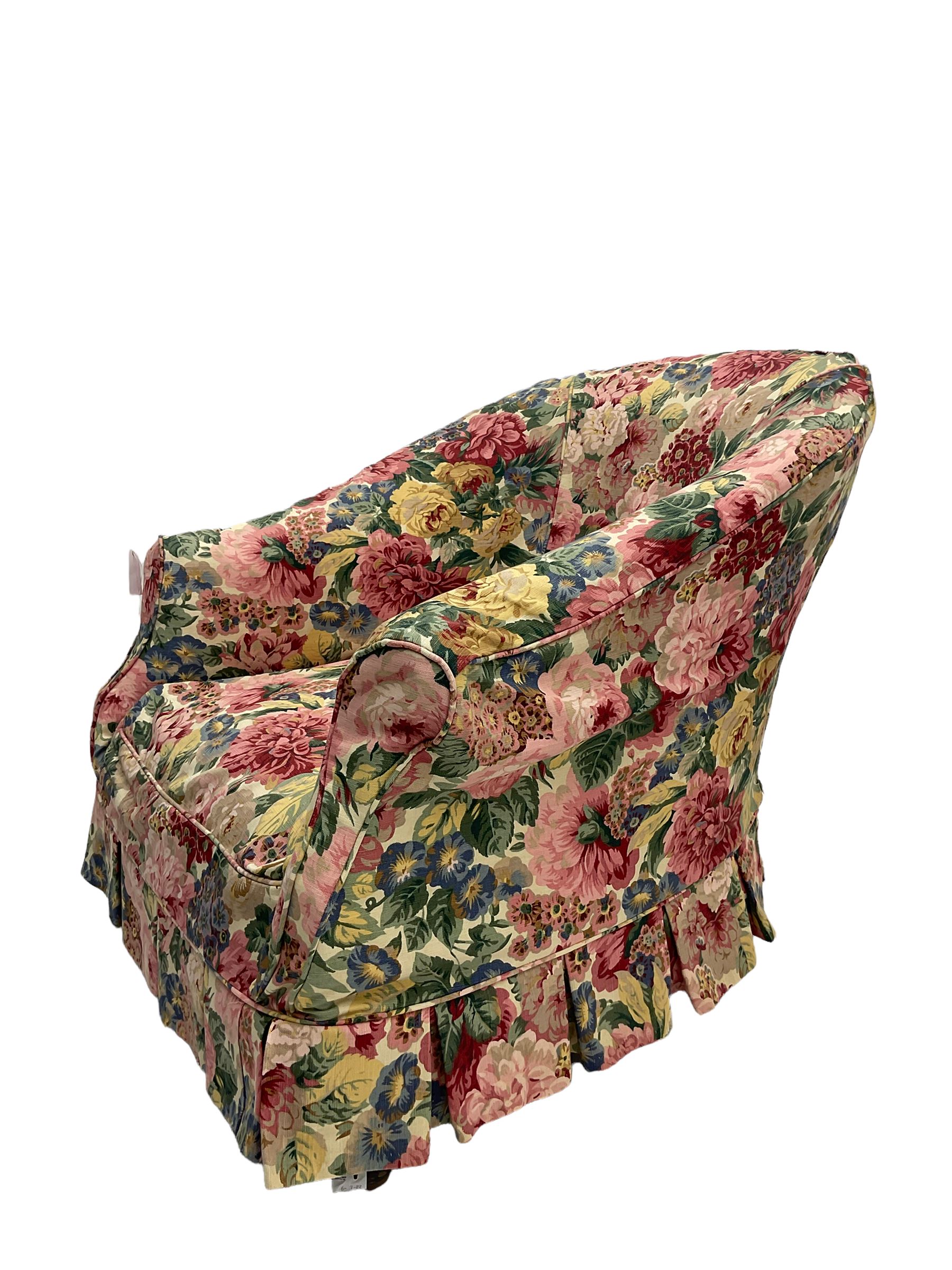 Victorian low tub shaped armchair, beech framed with compressed bun feet, loose floral fabric