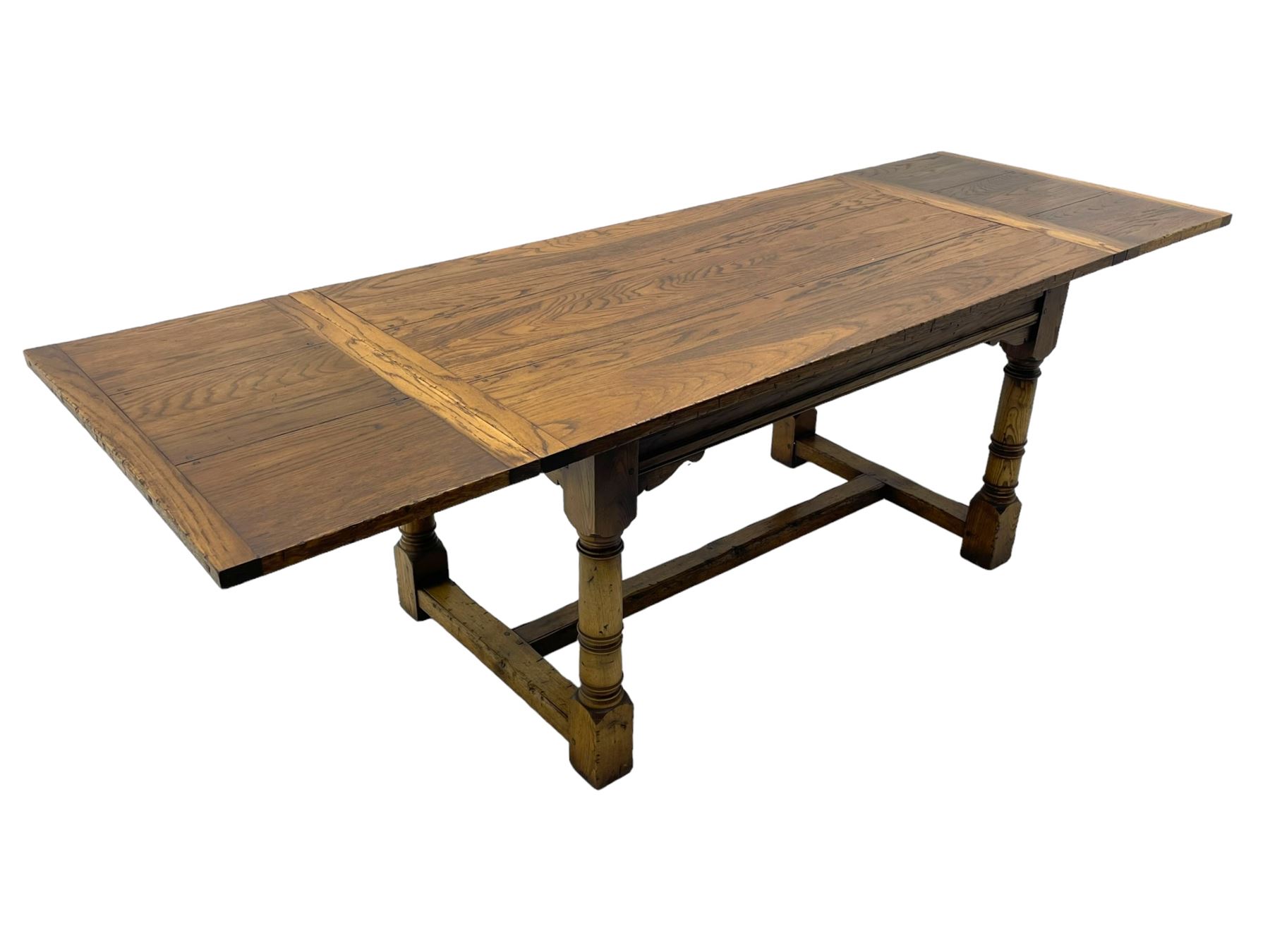 Oak refectory dining table, rectangular three plank top with cleated ends, two additional leaves, on turned supports united by H-stretchers 