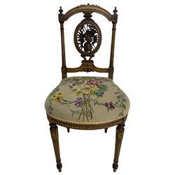 Late Victorian walnut side chair, arched cresting rail over carved and pierced splat depicting baskets and foliage, floral needle work upholstered seat, on acanthus carved and fluted turned supports