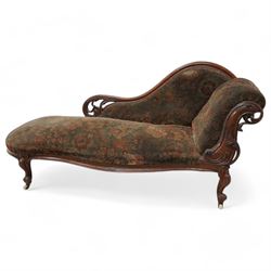 Mid-19th century mahogany chaise longue, shaped and rolled back carved and pierced with sc...