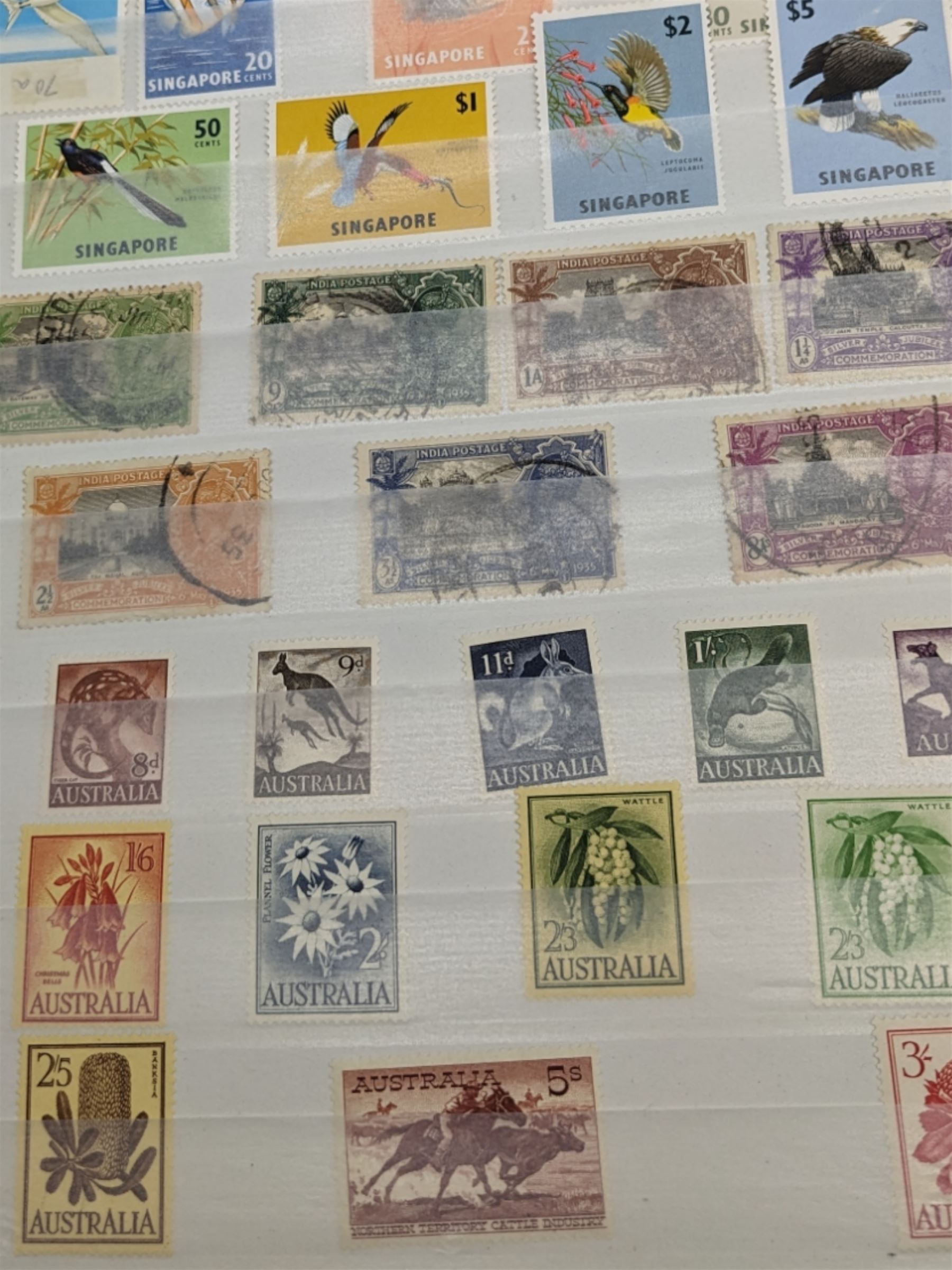 Mostly Commonwealth or Empire stamps including Queen Elizabeth II Northern Rhodesia, Nyasaland, Solomon Islands, Aden, Bermuda, Grenada 'Associated Statehood' overprints, King George VI Falkland Islands Dependencies with values to one shilling etc, mixture of mint and used, housed in a green stockbook