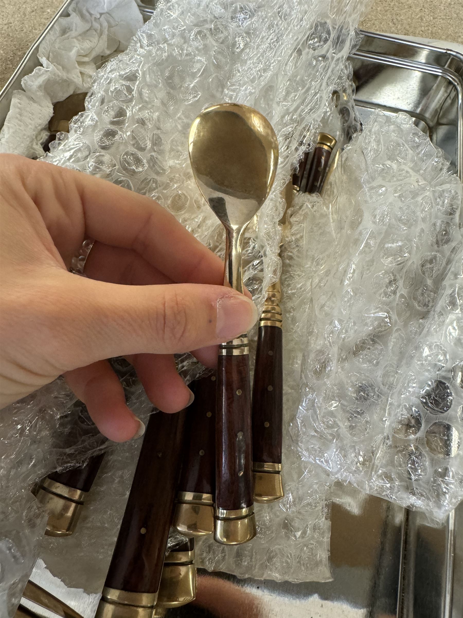 Wooden cased six place Thai gilt metal canteen of cutlery, together with additional matching flatware 