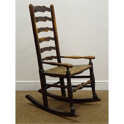  19th century elm ladder back rocking chair, rush seat, W56cm  