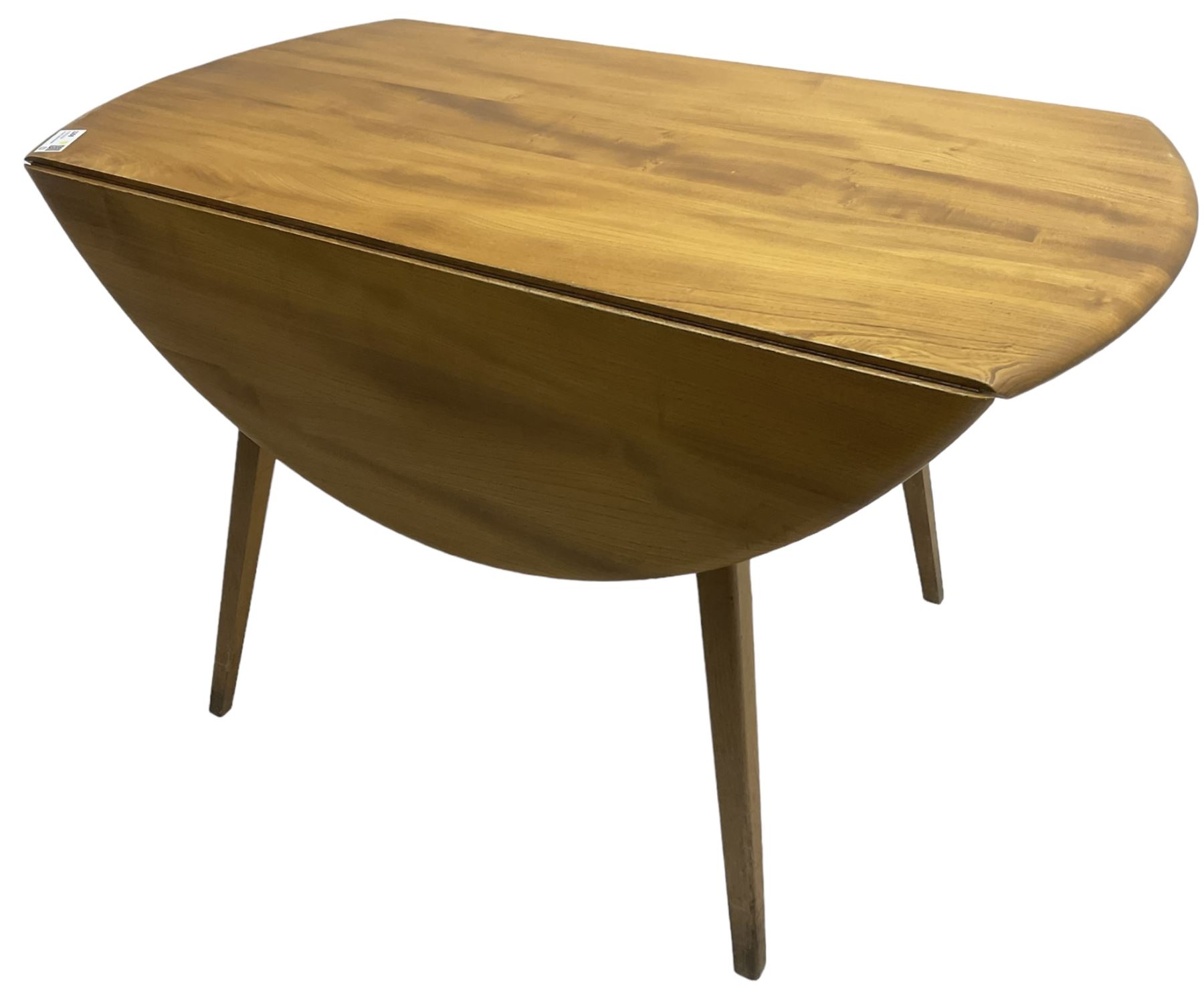 Ercol - mid-20th century golden elm drop-leaf dining table, circular top over splayed supports