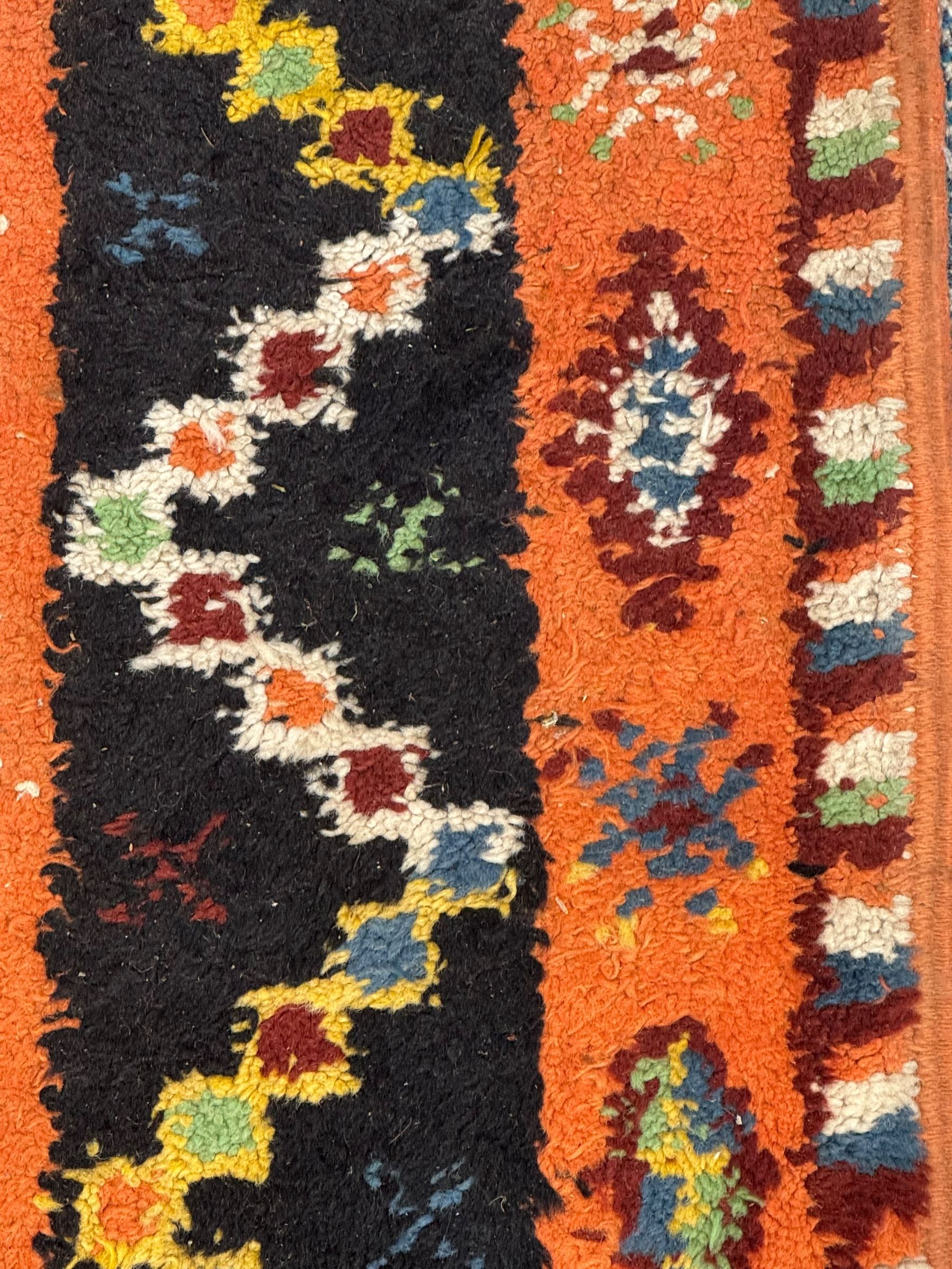 Moroccan amber ground thick pile rug, the field decorated with stylised geometric lozenges and camel motifs, the guard bands with stylised foliate and plant motifs