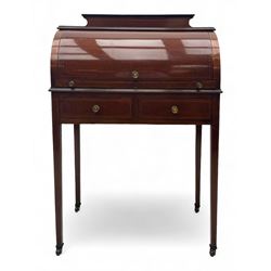 Edwardian inlaid mahogany roll-top desk, cylindrical lid enclosing fitted interior with pigeonholes, drawers and retractable writing surface, over two drawers with brass pull handles, on tapered supports with brass and ceramic castors