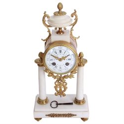 French - Louis XV style white marble and gilt mounted 8-day portico clock garniture c1905, drum movement surmounted by an oval shaped urn, supported on a pair of tapered column supports and raised on a rectangular plinth base, white enamel dial with floral garlands and Arabic numerals, Louis XV style gilt hands within a glazed bezel, twin train countwheel striking movement, striking the hours and half hours on a bell, with a pair of conforming three light candelabra, decorative matching pendulum and key.