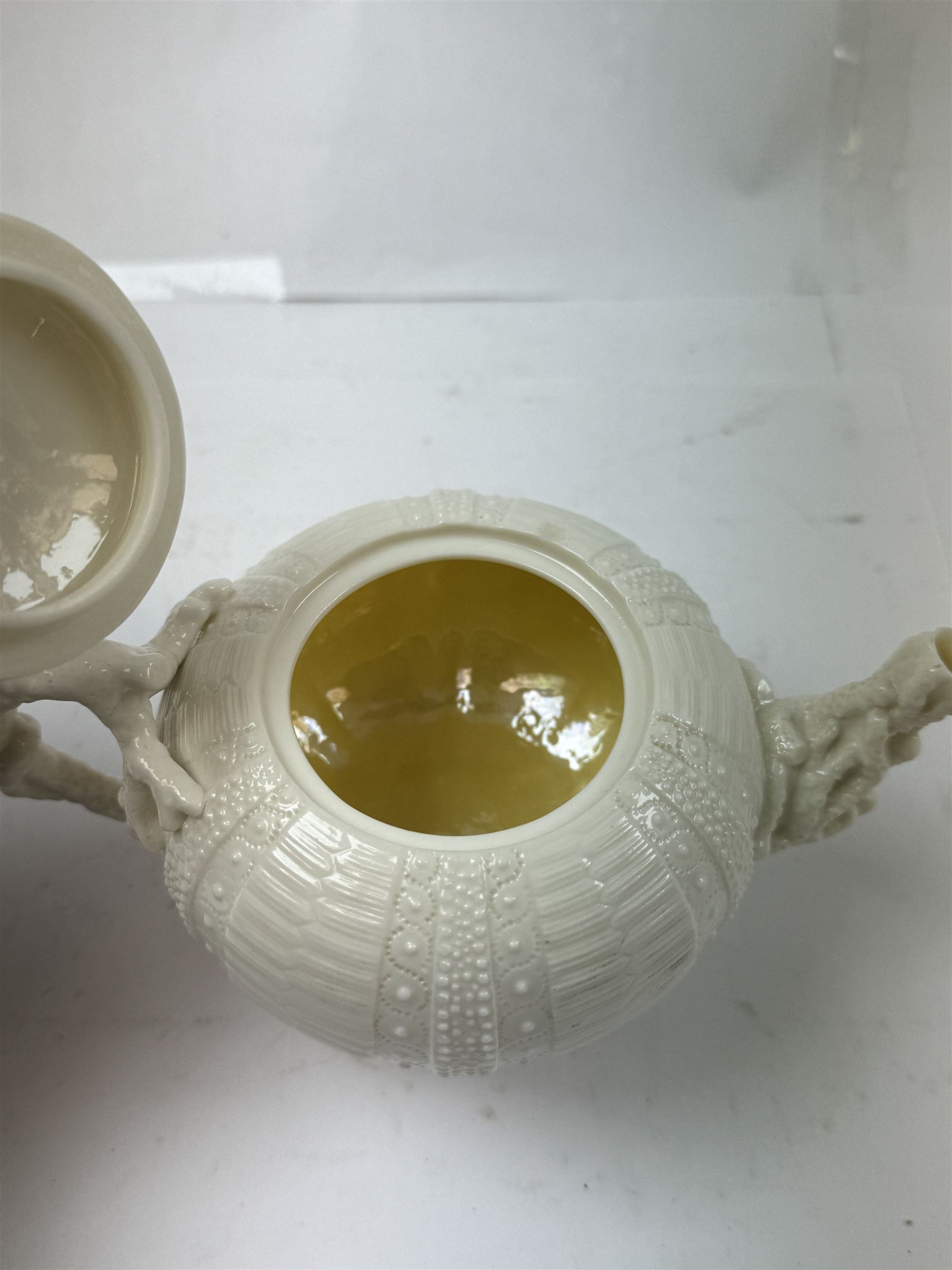 Belleek Sea Urchin teapot and sugar basin, together with Belleek Nautilus jug, small dish, teacup and saucer