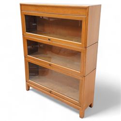 Angus Gunn - early 20th century light oak three sectional stacking bookcase, enclosed by hinged and sliding glazed doors