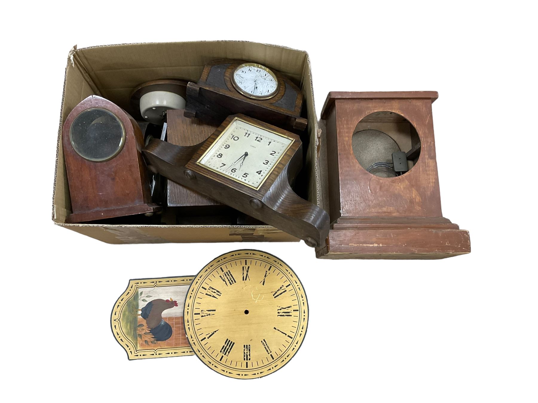 An assortment of mantle clocks and empty wooden cases