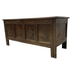 18th century oak coffer or chest, rectangular hinged panelled top with moulded frame enclosing candle box, the frieze carved with foliate S-scrolls over a quadruple panel front decorated with carved lozenges, on stile supports