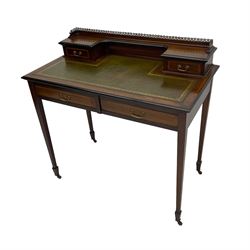 Edwardian inlaid mahogany writing desk, raised back with gilt metal gallery over two small drawers with satinwood banding, the rectangular moulded top with green leather inset writing surface, fitted with two drawers, on square tapering supports with spade feet, brass and ceramic castors 