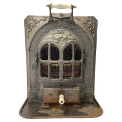 La Salamandre - early 20th century cast iron wood burning stove, decorated with salamander and cartouche motifs, fitted with porcelain handle, on rear castors 