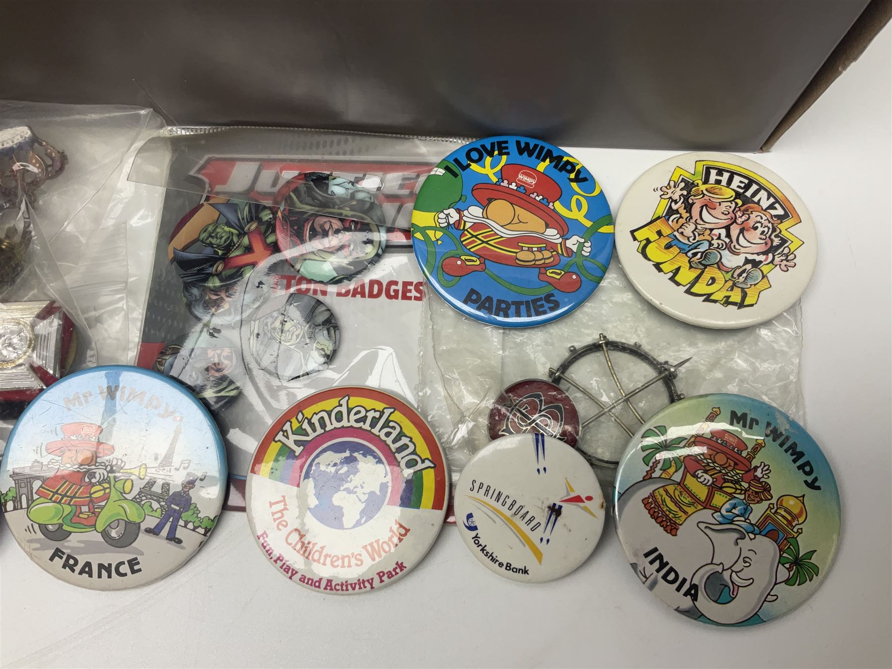 Four silver badges, military cap badges and a large collection of enamel badges, pin badges, plastic badges, brooches etc, including Disney examples