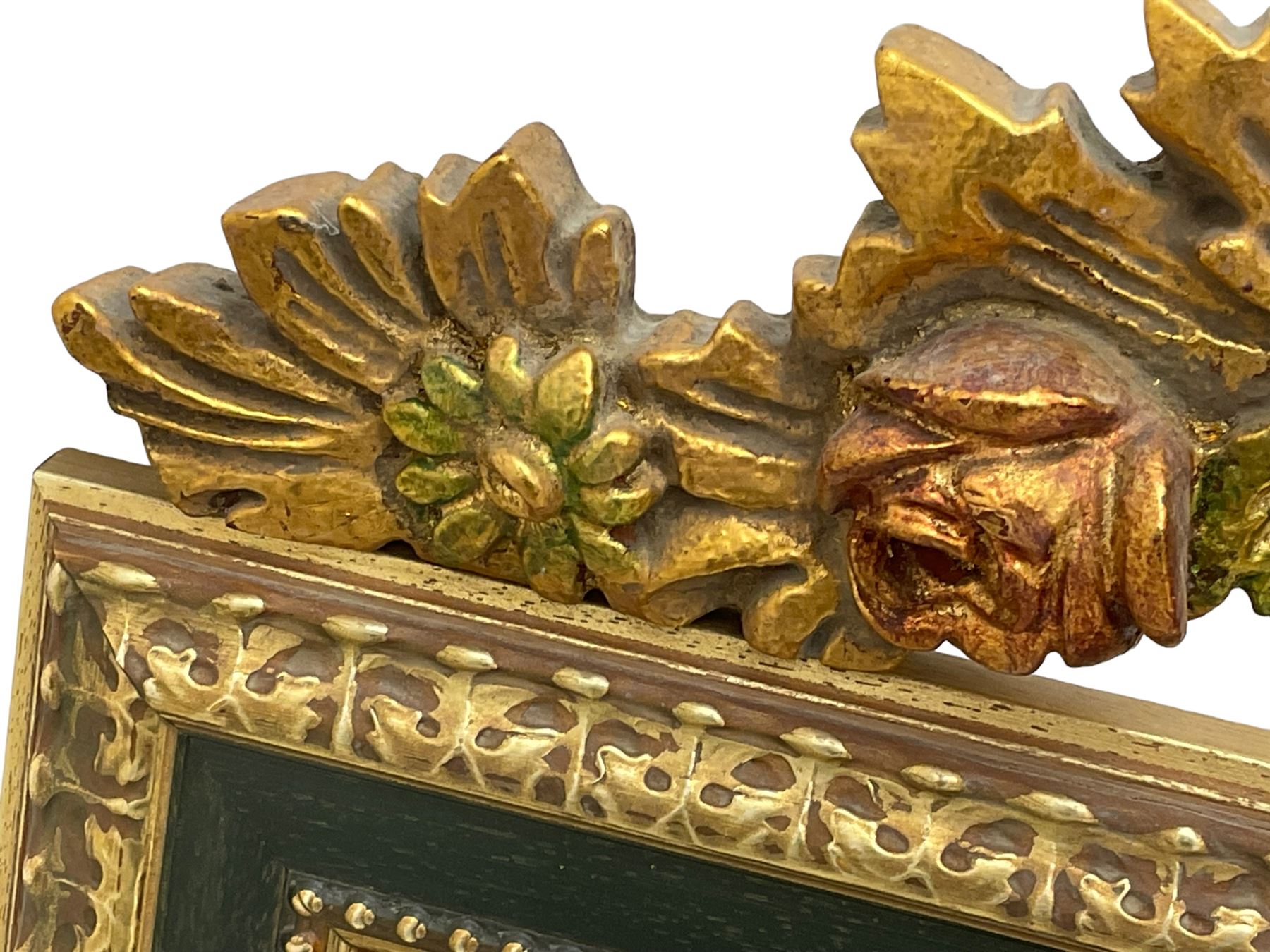 Spanish style wood and composite wall mirror, flower head pediment over plain mirror plate, foliate moulded frame