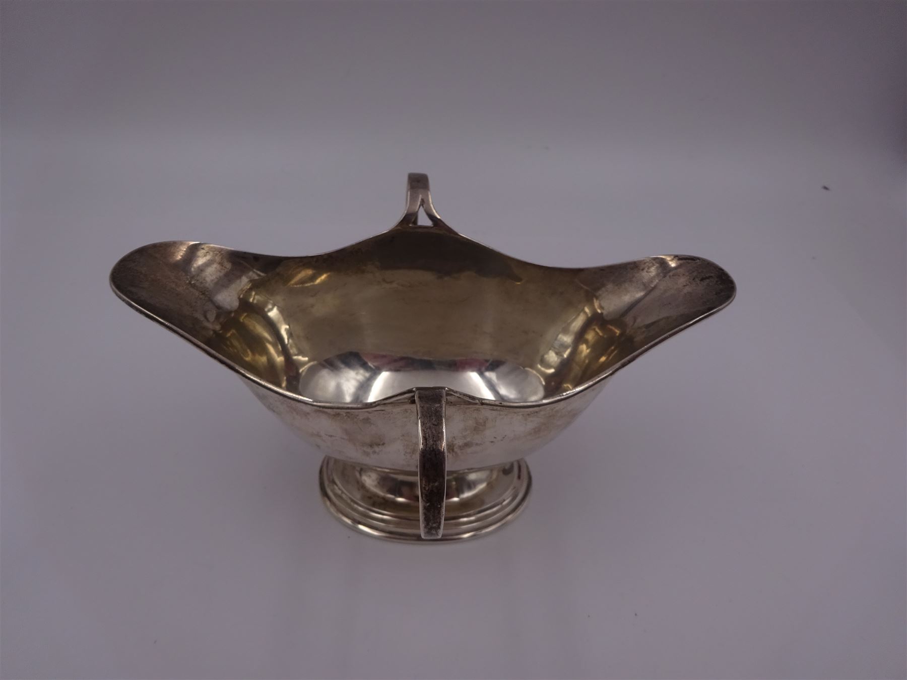 Edwardian silver twin handled pedestal dish, of navette shaped form, with twin loop handles, upon a stepped oval pedestal, hallmarked William Neale, Birmingham 1907, H9cm