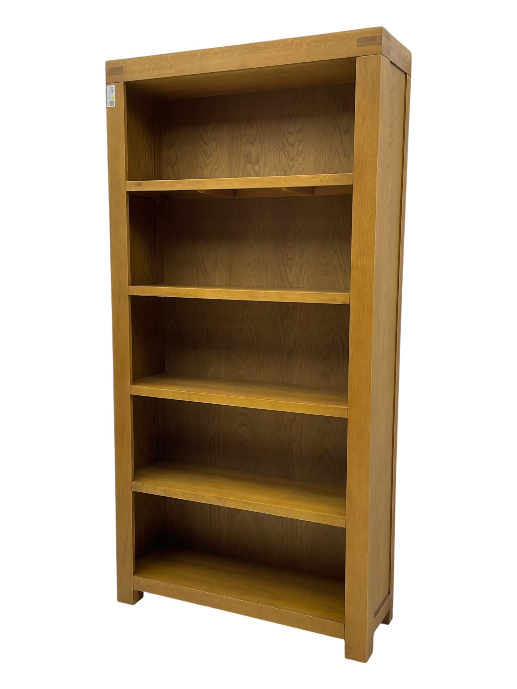 Light oak open bookcase fitted with four shelves 