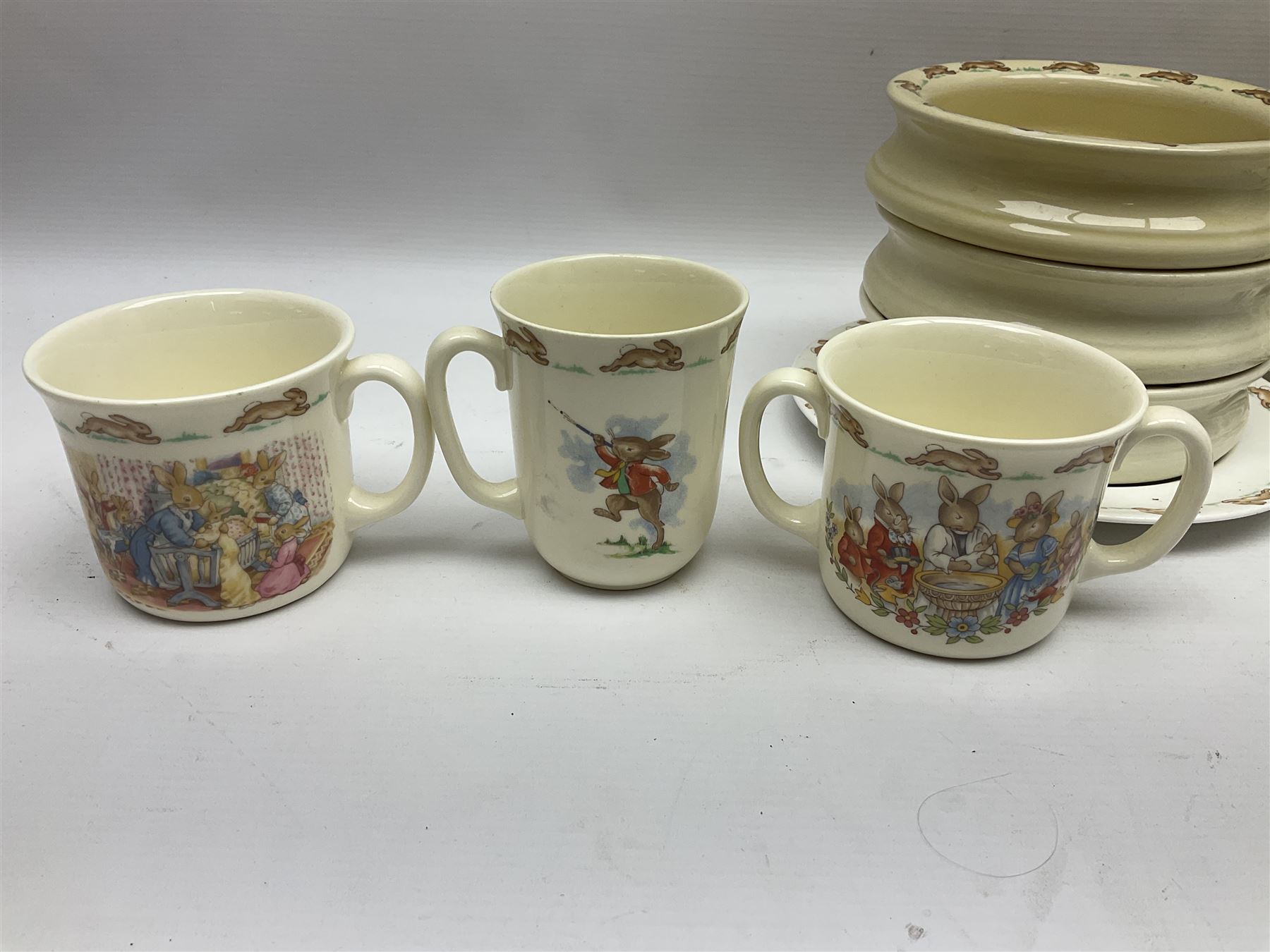 Royal Doulton Bunnykins nursery wares, including twin handled mugs, bowls, plates (17) 